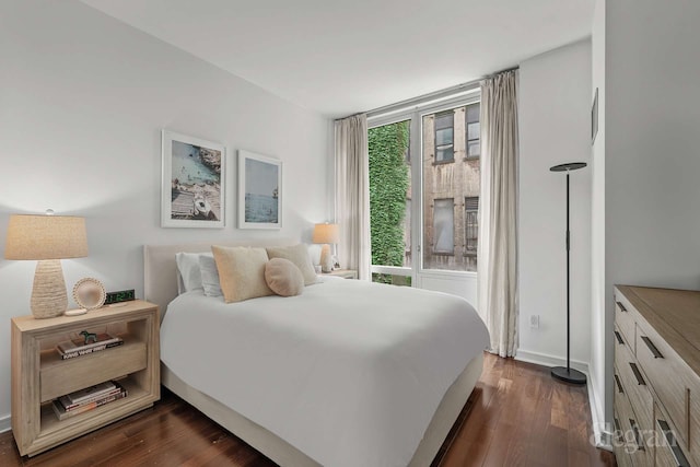 130 W 19th St Unit 4F, New York City, NY 10011 - bedroom with dark wood-style flooring