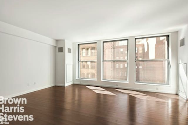 27 W 19th St Unit 7, New York City, NY 10011 - unfurnished room with wood finished floors, healthy amount of natural light, and baseboards