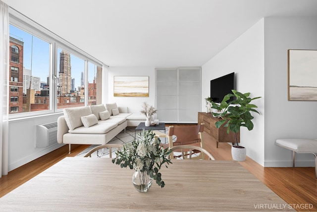353 E 72nd St Unit 20B, New York City, NY 10021 - living area with wood finished floors and an AC wall unit