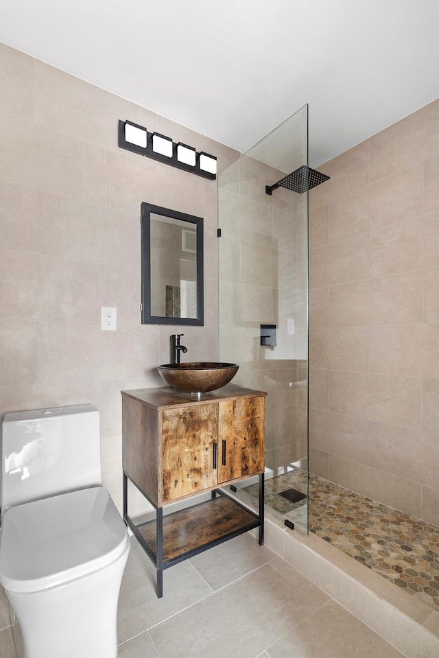 353 E 72nd St Unit 20B, New York City, NY 10021 - bathroom with tile walls, a walk in shower, vanity, and tile patterned flooring