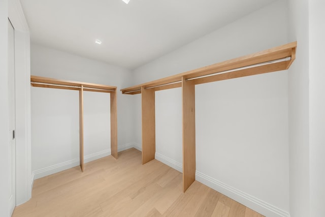 1 Wall St Unit 3606, New York City, NY 10005 - walk in closet with light wood-style floors