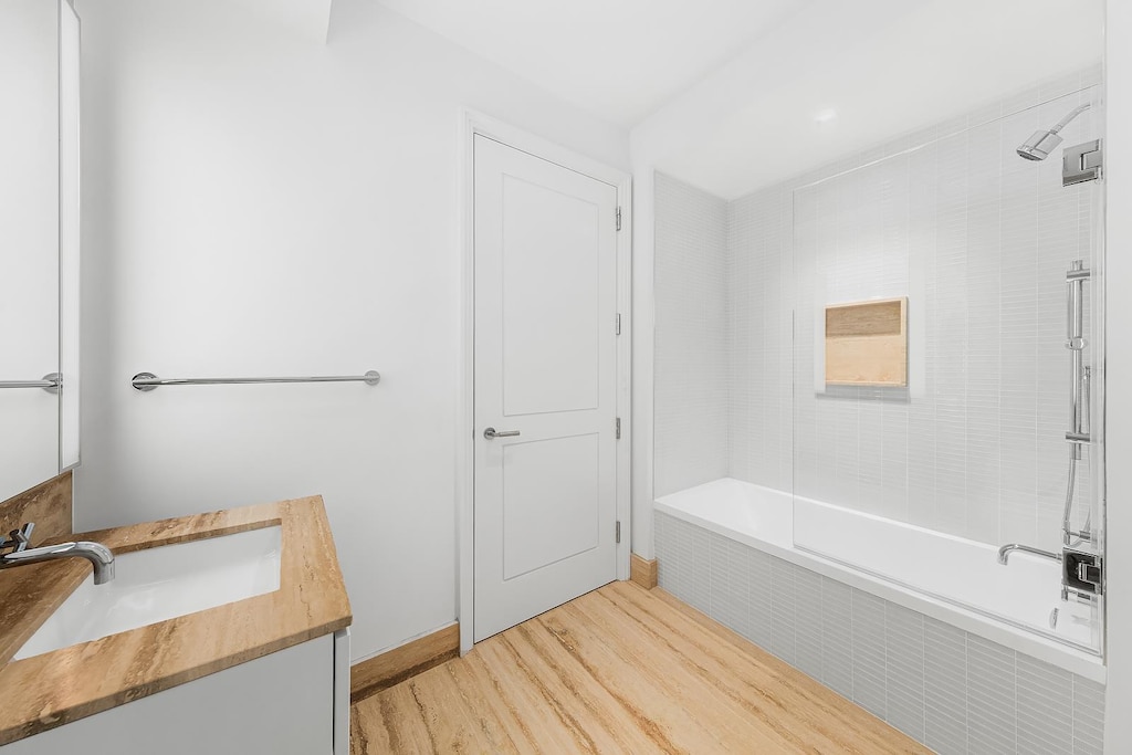 1 Wall St Unit 1116, New York City, NY 10005 - full bathroom featuring vanity, wood finished floors, and tiled shower / bath