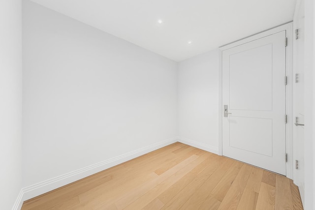 1 Wall St Unit 1116, New York City, NY 10005 - unfurnished room with light wood finished floors, baseboards, and recessed lighting