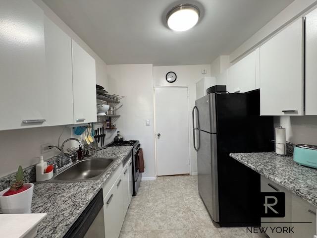 5500 Fieldston Rd Unit 4-Ee, New York City, NY 10471 - kitchen featuring appliances with stainless steel finishes, white cabinets, open shelves, light stone counters, and light tile patterned flooring