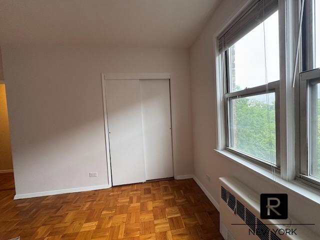 5500 Fieldston Rd Unit 4-Ee, New York City, NY 10471 - unfurnished bedroom with radiator and a closet