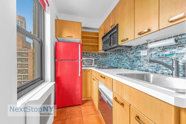 200 E 36th St Unit 13A, New York City, NY 10016 - kitchen featuring freestanding refrigerator, black microwave, a sink, stainless steel microwave, and light countertops