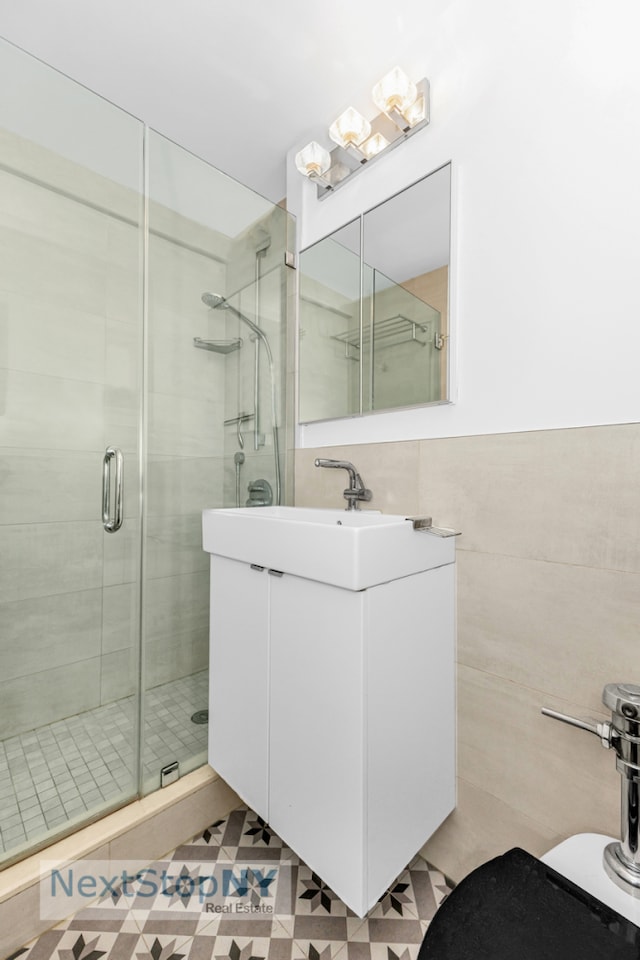 200 E 36th St Unit 13A, New York City, NY 10016 - full bathroom featuring a stall shower, vanity, tile walls, and toilet