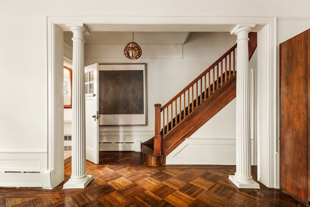 216 E 21st St, New York City, NY 11226 - entrance foyer featuring ornate columns, stairs, a baseboard radiator, and baseboard heating