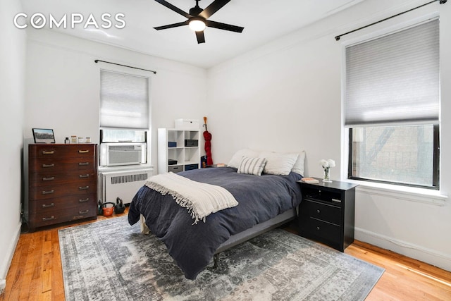 668 Riverside Dr Unit 3G, New York City, NY 10031 - bedroom with radiator heating unit, multiple windows, and light wood-style floors