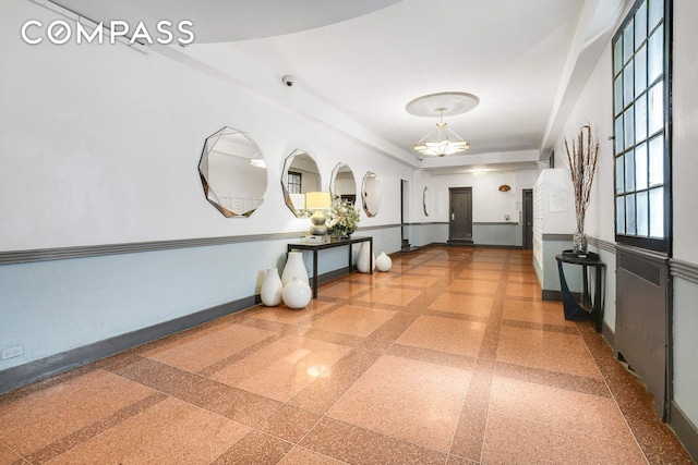 668 Riverside Dr Unit 3G, New York City, NY 10031 - hallway with baseboards and a chandelier