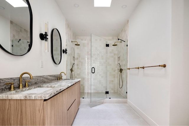 45 Cornelia St, New York City, NY 11221 - full bathroom with a shower stall, double vanity, tile patterned flooring, and baseboards