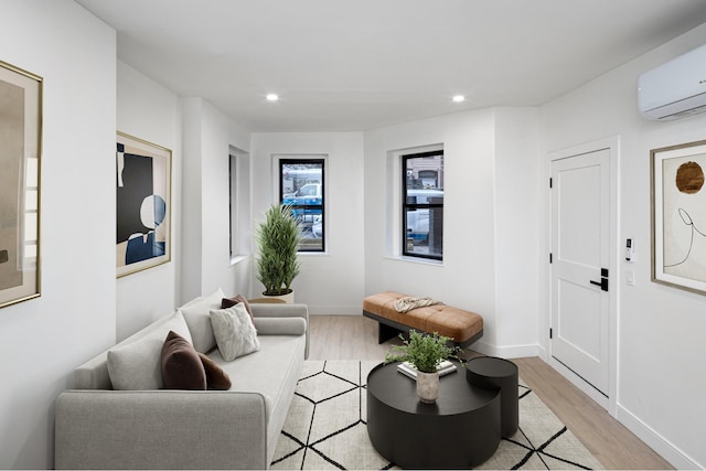 45 Cornelia St, New York City, NY 11221 - living room featuring light wood-style flooring, recessed lighting, an AC wall unit, and baseboards