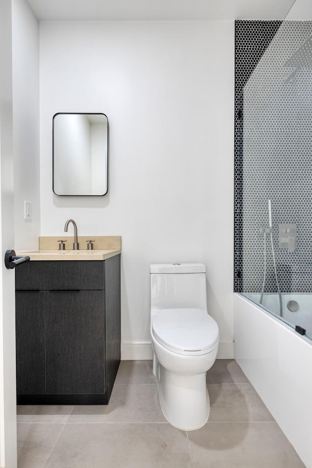 45 Cornelia St, New York City, NY 11221 - bathroom featuring toilet, vanity, enclosed tub / shower combo, tile patterned flooring, and baseboards