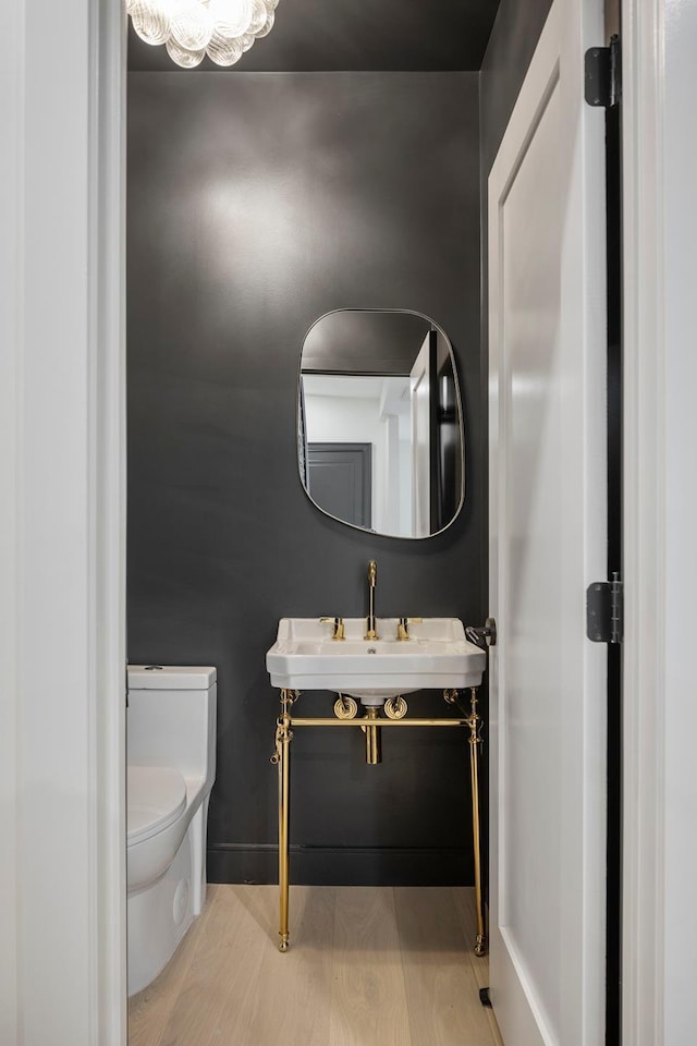 45 Cornelia St, New York City, NY 11221 - bathroom with toilet, a sink, and wood finished floors