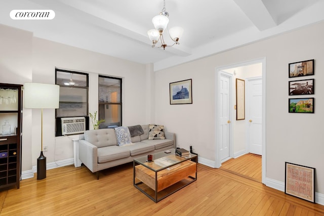 142 E 49th St Unit 2C, New York City, NY 10017 - living area featuring a chandelier, light wood finished floors, cooling unit, and baseboards