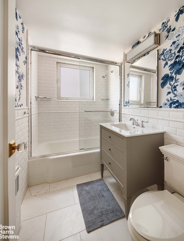 45 Sutton Pl S Unit 16/O, New York City, NY 10022 - full bath with toilet, combined bath / shower with glass door, vanity, and tile walls