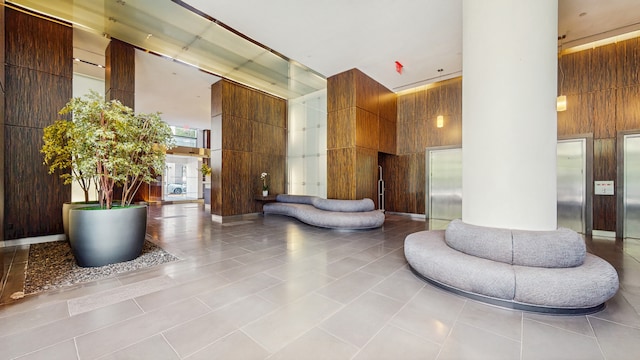 310 W 52nd St Unit 17A, New York City, NY 10019 - lobby with a towering ceiling and wooden walls