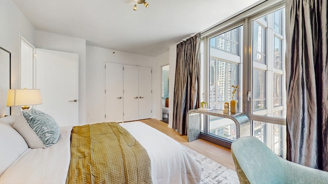 310 W 52nd St Unit 17A, New York City, NY 10019 - bedroom featuring wood finished floors and a closet