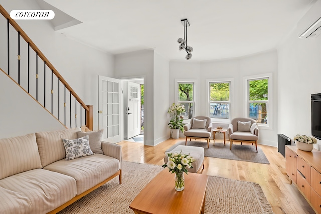 580 E 7th St, New York City, NY 11218 - living room featuring an AC wall unit, light wood-style flooring, stairs, and baseboards