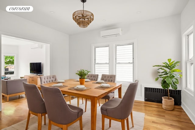 580 E 7th St, New York City, NY 11218 - dining room with radiator heating unit, a wall mounted AC, a chandelier, and light wood-style flooring