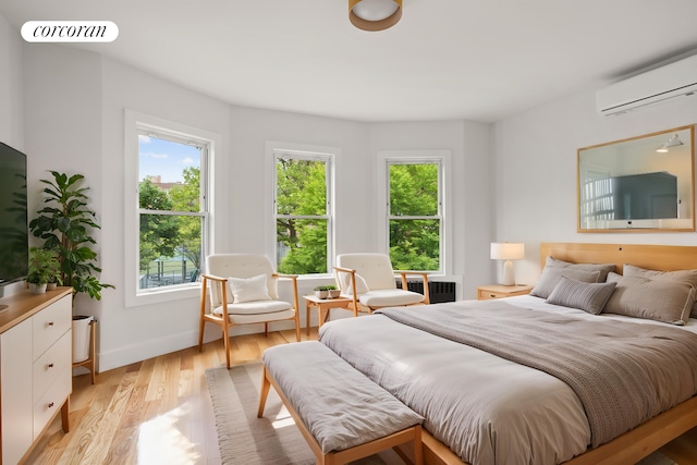 580 E 7th St, New York City, NY 11218 - bedroom with a wall unit AC, light wood-style flooring, and radiator