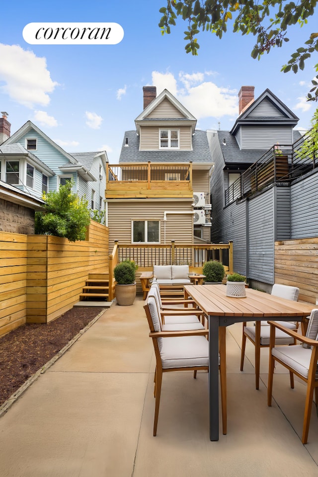 580 E 7th St, New York City, NY 11218 - rear view of house featuring outdoor dining area, a balcony, a chimney, roof with shingles, and a patio area