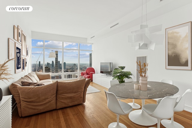 151 E 58th St Unit 42C, New York City, NY 10022 - living room with wood finished floors