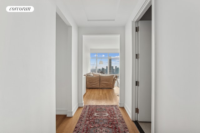 151 E 58th St Unit 42C, New York City, NY 10022 - corridor featuring light wood-style flooring, attic access, and baseboards