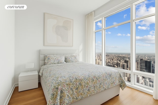 151 E 58th St Unit 42C, New York City, NY 10022 - bedroom with wood finished floors and baseboards
