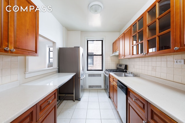 221 E 18th St Unit 5F, New York City, NY 11226 - kitchen featuring stainless steel appliances, backsplash, under cabinet range hood, and light countertops