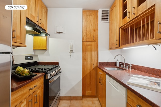 175 W 13th St Unit 7E, New York City, NY 10011 - kitchen featuring stainless steel range with gas stovetop, dishwasher, under cabinet range hood, light tile patterned floors, and glass insert cabinets