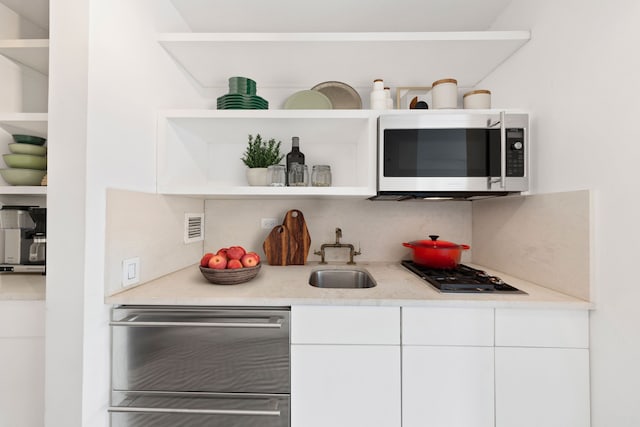 500 W 43rd St Unit 3C, New York City, NY 10036 - bar area featuring stainless steel appliances, a sink, and decorative backsplash