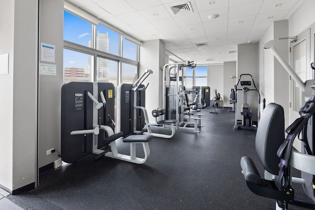 500 W 43rd St Unit 3C, New York City, NY 10036 - workout area featuring a drop ceiling, expansive windows, and baseboards