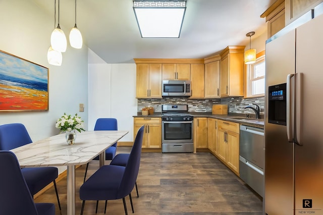 118 Stobe Ave, New York City, NY 10306 - kitchen featuring stainless steel appliances, dark countertops, a sink, backsplash, and dark wood-type flooring