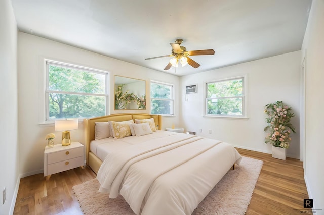 118 Stobe Ave, New York City, NY 10306 - bedroom featuring a wall mounted AC, light wood-style floors, baseboards, and ceiling fan