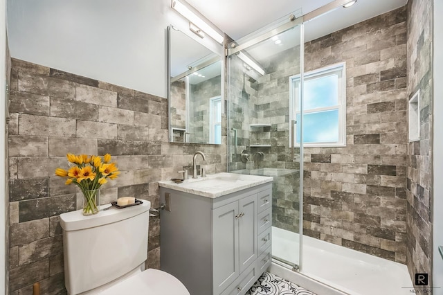 118 Stobe Ave, New York City, NY 10306 - bathroom with tile walls, vanity, toilet, and a stall shower