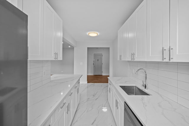 43-25 43rd St Unit 5D, New York City, NY 11104 - kitchen with a sink, stainless steel appliances, white cabinetry, and decorative backsplash
