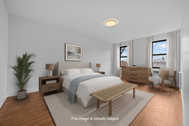 43-25 43rd St Unit 5D, New York City, NY 11104 - bedroom featuring wood finished floors and baseboards