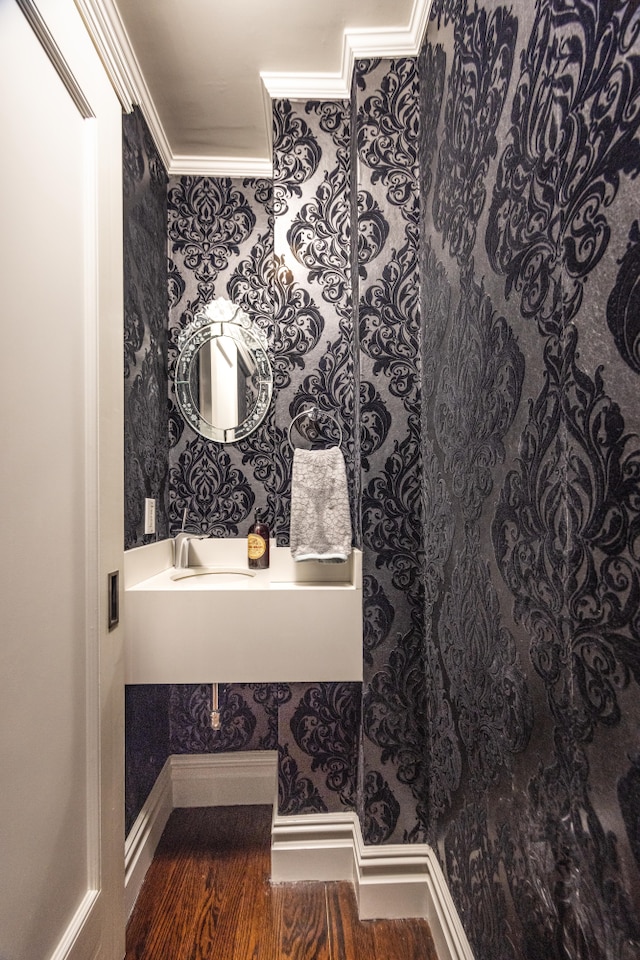59 W 71st St Unit 4D, New York City, NY 10023 - bathroom featuring wallpapered walls, ornamental molding, and wood finished floors