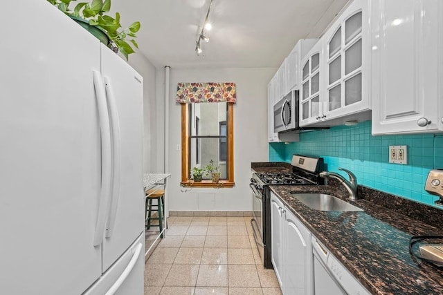 7609 4th Ave Unit D9, New York City, NY 11209 - kitchen with stainless steel appliances, white cabinets, tasteful backsplash, and glass insert cabinets