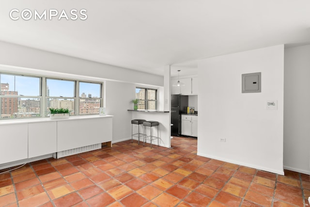 609 Columbus Ave Unit 14E, New York City, NY 10024 - unfurnished living room featuring electric panel and light tile patterned floors