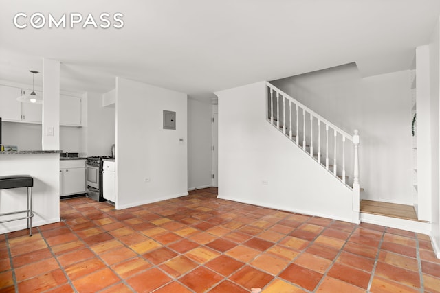 609 Columbus Ave Unit 14E, New York City, NY 10024 - unfurnished living room featuring stairs and light tile patterned flooring