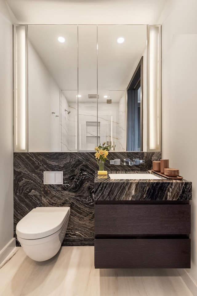 125 Greenwich St Unit 52D, New York City, NY 10006 - bathroom featuring vanity, a marble finish shower, and recessed lighting