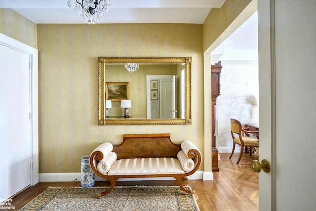 575 Park Ave Unit 509, New York City, NY 10065 - sitting room featuring a chandelier, baseboards, wallpapered walls, and parquet flooring