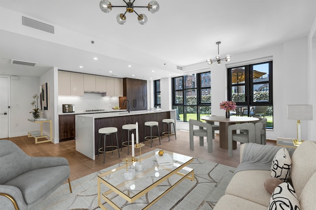 11 Hancock Pl Unit 304, New York City, NY 10027 - living room featuring a chandelier, light wood-style flooring, recessed lighting, and baseboards
