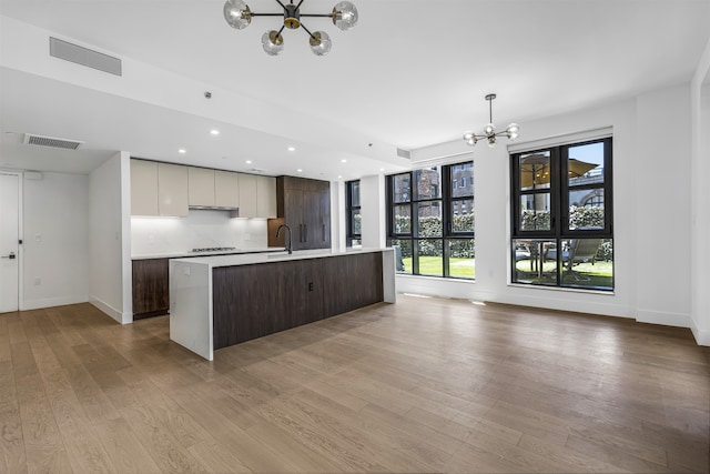 11 Hancock Pl Unit 304, New York City, NY 10027 - kitchen featuring a chandelier, modern cabinets, light countertops, light wood-style flooring, and recessed lighting
