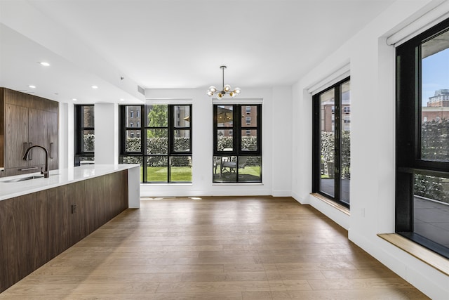 11 Hancock Pl Unit 304, New York City, NY 10027 - kitchen with a sink, a chandelier, plenty of natural light, wood-type flooring, and recessed lighting