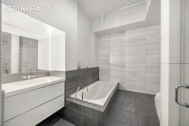36 W 15th St Unit 4, New York City, NY 10011 - full bathroom with tile walls, tile patterned floors, a bath, and vanity
