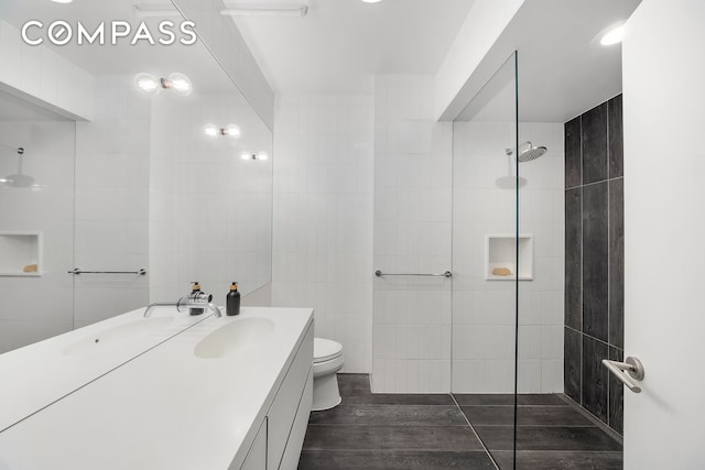36 W 15th St Unit 4, New York City, NY 10011 - full bathroom featuring vanity, walk in shower, toilet, tile walls, and wood finished floors