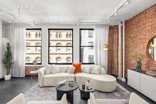 36 W 15th St Unit 4, New York City, NY 10011 - living area featuring brick wall, wood finished floors, and rail lighting